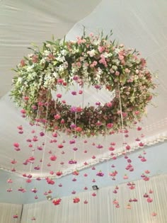 an arrangement of flowers hanging from the ceiling