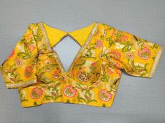 Buy a beautiful yellow color Indian saree designer blouse with floral print. You can pair up with any Indian Saree for any occasion to make your look elegant. A yellow multicolor floral blouse is a woven design padded saree blouse that has a V neck,  a beautiful back, and hook closure. You can pair it with any Indian Saree, Banarasi Silk Sarees, and Chanderi Silk sarees. Buy it from Pure Elegance sari blouse from Pure Elegance Indian clothing store in the USA.- Front View Saree Designer Blouse, Saree Designer, Chanderi Silk Saree, Indian Saree Blouse, Fashion Journals, Pure Elegance, Yellow Silk, Sari Blouse, Floral Designer