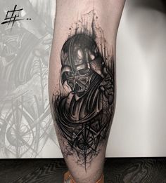 a black and white tattoo on the leg of a man with a skull in it