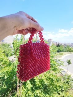 Bags are 100% Handmade.The beads do not deform. They do not peel off.Its size is suitable for wallets, keychains, lipsticks, etc.Chain length is 1 m. If you want, you can adjust the length by removing the attachments.   Material:Acrylic beads 8 mm Dimensions Height:11 cm  inner height:10 cm Width:14 cm  inner width:12 cm Depth:4 cm You can contact us for your requests. Red Beaded Clutch Evening Bag, Red Beaded Rectangular Evening Bag, Handmade Red Clutch Evening Bag, Red Beaded Evening Bag As Gift, Everyday Red Beaded Bags, Red Beaded Rectangular Shoulder Bag, Red Beaded Bag As Gift, Red Beaded Bag For Gift, Handmade Red Bags Fashion Accessory