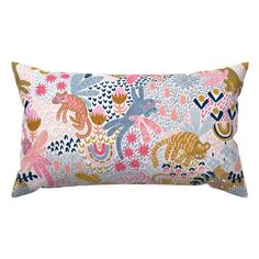 a rectangular pillow with colorful flowers and animals on the front, along with a white background