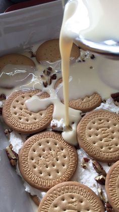 a pan filled with cookies and milk being poured into it