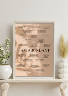 i am abundant print on a shelf next to some vases and white planters