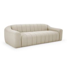 a white couch sitting on top of a white floor