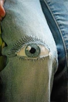 someone is holding their jeans with an eye on it