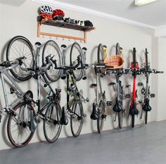 there is a bike rack with many bikes hanging on the wall next to it,