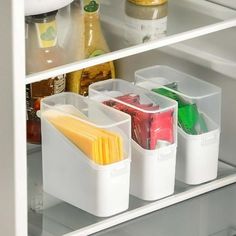 an open refrigerator door with food and drinks in containers on the bottom shelf next to it