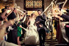 the bride and groom walk down the aisle as confetti is thrown around them