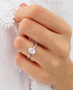 a woman's hand with a diamond ring on it