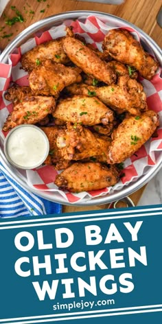 old bay chicken wings in a bowl with ranch dressing on the side and text overlay