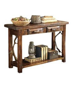 a wooden table topped with books and a bowl of fruit on top of it's shelf