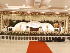 a decorated stage with white and red flowers