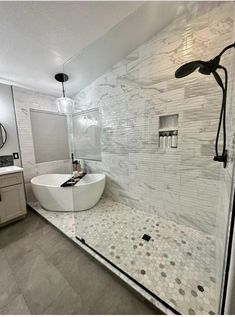 a large white bathtub sitting next to a walk in shower