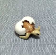 there is a small toy animal that has been made out of clay on the floor