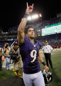 a football player holding his hand up in the air