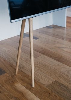 a tv sitting on top of a wooden stand