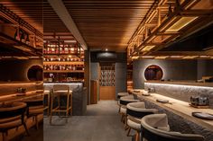 the interior of a restaurant with wooden tables and chairs