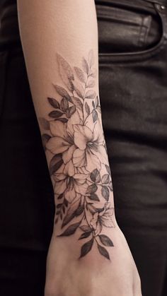 a woman's arm with flowers on it