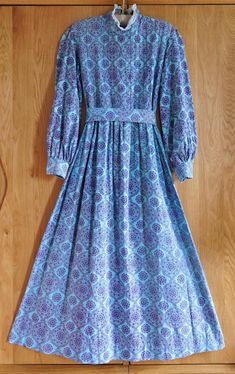 This super special early Laura Ashley Prairie dress is such a delightful dream! A very iconic Victorian Revival design from the late 1960s.  Dreamy, romantic, Victorian-inspired, and absolutely eye-catching.  55cm across armpits 46cm across waist but it can be adjusted by the matching belt.  130cm shoulder to hem  137cm back collar to hem It is suitable for a range of sizes. Excellent Vintage Condition but please do not expect it is flawless. This dress is not new and show light signs of age and Laura Ashley Vintage Dress Victorian, Bohemian Dresses With Vintage Pattern, Fitted Bohemian Prairie Dress For Daywear, Bohemian Long Sleeve Prairie Dress, Bohemian Prairie Dress For Daywear, Artistic Dress, Revival Design, Hippie Cottagecore, Victorian Revival