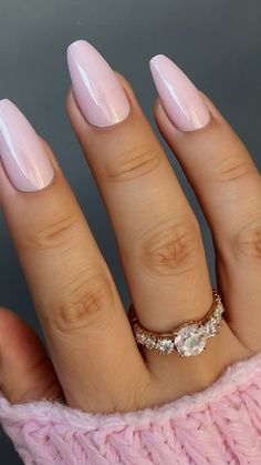 a woman's hand with pink manies and a diamond ring on it,