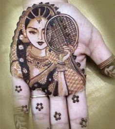 a woman's hand is decorated with hennap and flowers, holding a tennis racket