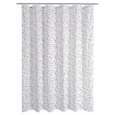 a white shower curtain with multicolored polka dots