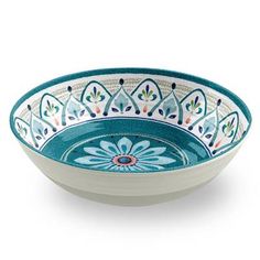 a blue and white bowl with an ornate design on the rim, sitting on a white surface