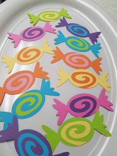 colorful paper cut outs on a white plate