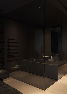 a bathroom with a large glass shower stall and sink area in the middle of it