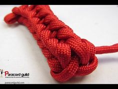 a close up of a red rope on a white surface