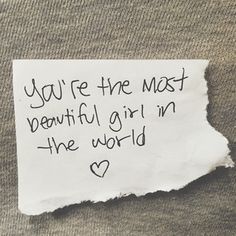 a piece of paper with the words you're the most beautiful girl in the world written on it