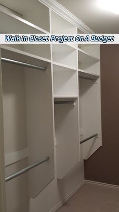 an empty walk in closet with white shelves