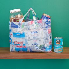 a grocery bag sitting on top of a wooden shelf next to a can of soda