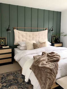 a bedroom with green painted walls and white linens on the bed, along with two nightstands