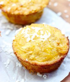 two coconut muffins sitting on top of white paper