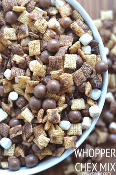 a white bowl filled with chocolate and marshmallow chex mix