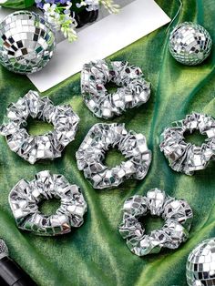 disco balls and other decorations on a green cloth