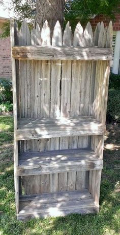 an old wooden book shelf sitting in the grass