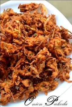 a white plate topped with fried food on top of a table