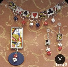 a necklace with dices, cards and charms hanging from it's sides on a table