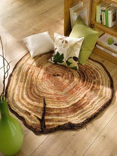 a living room with wood flooring and green vase