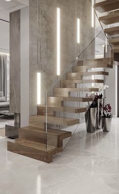 a modern staircase with wood and glass railing