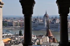 view from the top of a building looking down on a river and buildings in the distance