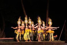 the dancers are dressed in yellow and brown costumes with feathers on their heads, arms and legs