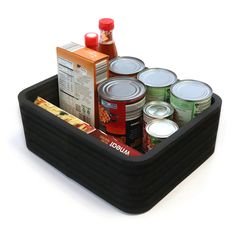 a black container filled with canned food and condiments