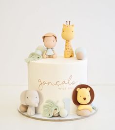 a white cake with animals and giraffes on top