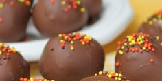 chocolate covered candy balls with sprinkles on them