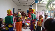 several clowns are standing in front of a group of people