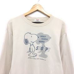 a t - shirt with a snoopy cartoon on the front and words around it