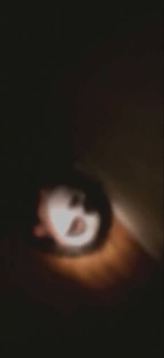 a blurry image of a person's face in the dark with their eyes closed